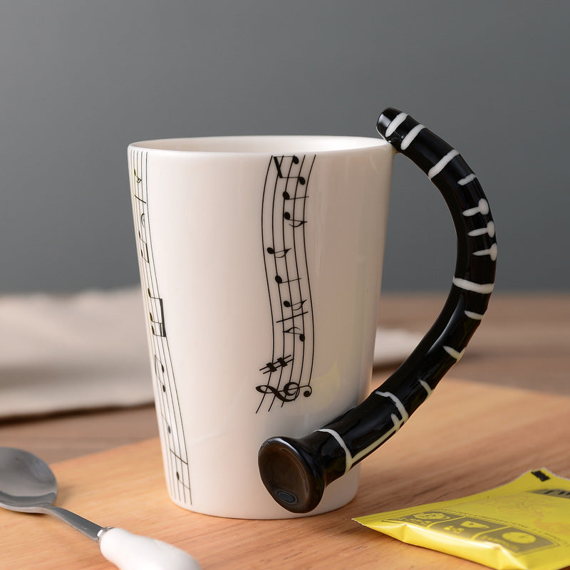 Coffee cup with music notes in the form of saxophone handle ceramic porcelain cup of tea milk method